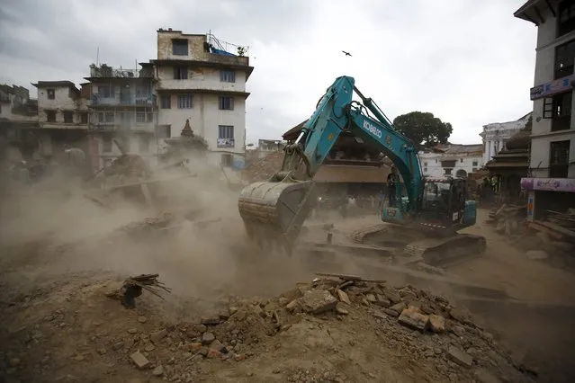 An excavator digs the rubble to search for the bodies after an earthquake hit, in Kathmandu, Nepal April 25, 2015. (Photo by Navesh Chitrakar/Reuters)