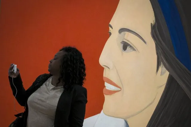 A woman takes a selfie photo with the “Red Smile” by Alex Katz during the opening preview at The Whitney Museum of American Art in New York April 23, 2015. (Photo by Brendan McDermid/Reuters)