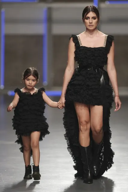 Model Magali Aravena and her daugther present creations by Portuguese designer Micaela Olveira during the Portugal Fashion show in Porto, Portugal, 16 March 2019. (Photo by Jose Coelho/EPA/EFE)