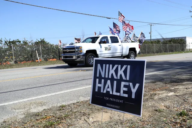 A supporter of Republican presidential candidate former President Donald Trump drives past Republican presidential candidate former UN Ambassador Nikki Haley's campaign event on Thursday, February 1, 2024, in Columbia, S.C. (Photo by Artie Walker Jr./AP Photo)