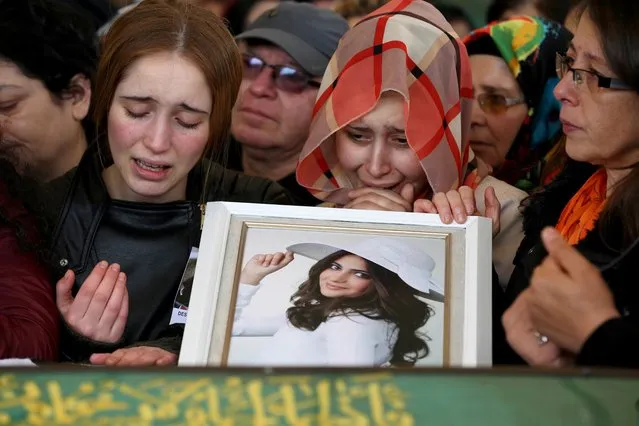 Relatives and friends of Destina Peri Parlak, one of the victims of the suicide bomb attack on March 13, mourn at her coffin during a funeral ceremony in Ankara on March 15, 2016. Turkish warplanes pounded Kurdish rebel bases in northern Iraq on March 14, the day after a suicide car bomb tore through downtown Ankara killing at least 36 people, the third attack on the capital in five months. (Photo by Adem Altan/AFP Photo)