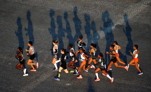 Runners compete on the Champs-Elysees in Paris during the 43rd Paris Marathon on April 14, 2019. (Photo by Regis Duvignau/Reuters)