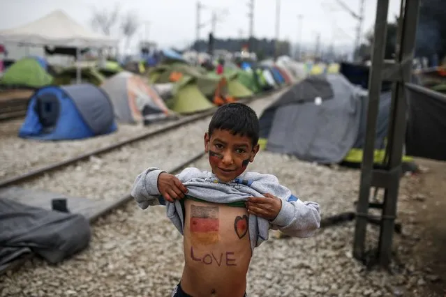 A child shows his chest painted in the colours of the German flag at a makeshift camp for migrants and refugees at the Greek-Macedonian border near the village of Idomeni, Greece, April 3, 2016. (Photo by Marko Djurica/Reuters)