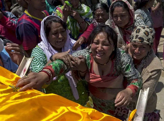 Relatives of an earthquake victim who died in Tuesday's earthquake cry as they see the body at Charikot Village, in Dolakha, Nepal, May 14, 2015. (Photo by Athit Perawongmetha/Reuters)