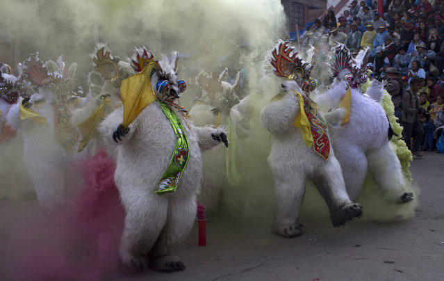 In this Saturday, February 25, 2017 photo, dancers perform the traditional “Diablada” or Dance of the Devils during the Carnival of Oruro, in Oruro, Bolivia. The carnival is a religious festival dating back more than 200 years in an ongoing pagan-Catholic blend of religious practice in the region, and is one of UNESCO's Masterpieces of the Oral and Intangible Heritage of Humanity. (Photo by Juan Karita/AP Photo)