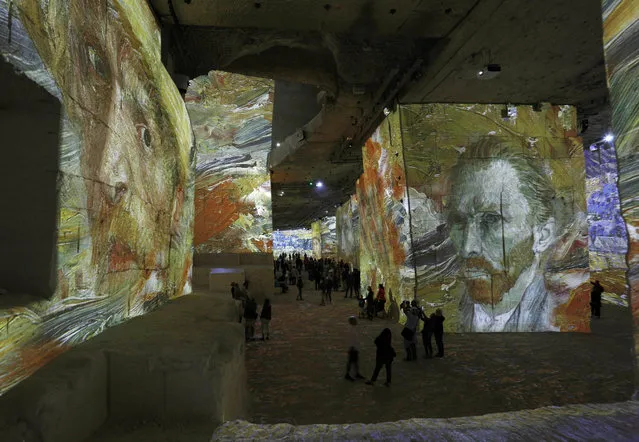 People attend an exhibition of projections of the most famous works of art by Vincent van Gogh at Carrieres de Lumiere in Les Baux-de-Provence, France on June 15, 2019. (Photo by Action Press/Rex Features/Shutterstock)