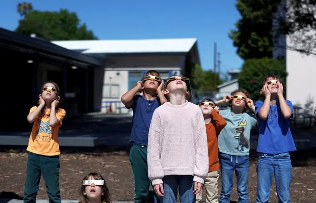 Students watch a partial solar eclipse at Benjamin Franklin Elementary Magnet School in Glendale, California, U.S., April 8, 2024. (Photo by Mario Anzuoni/Reuters)