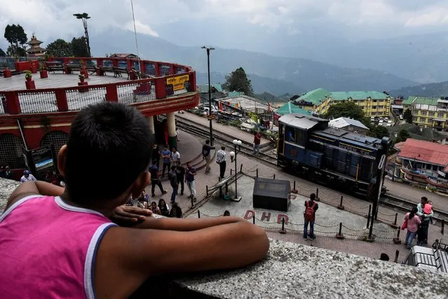 An engine belonging to the Darjeeling Himalayan Railway, which runs on a 2 foot gauge railway and is a UNESCO World Heritage Site, leaves a station in Darjeeling, India, June 24, 2019. (Photo by Ranita Roy/Reuters)