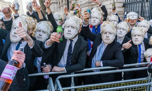 A group of men dressed as Boris Johnson stage a humurous mock lockdown party protest outside Downing Street, London on January 14, 2022 as they chant “Boris loves a party”. Prime Minister Boris Johnson has admitted at PMW on wednesday that he attended a garden party at Downing Street on 20 May 2020 during strict coronavirus restrictions. (Photo by Amer Ghazzal/Rex Features/Shutterstock)