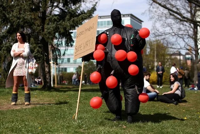 A demonstrator is dressed up as a coronavirus to protest against COVID-19 measures in Vienna, Austria, April 10, 2021. (Photo by Lisi Niesner/Reuters)