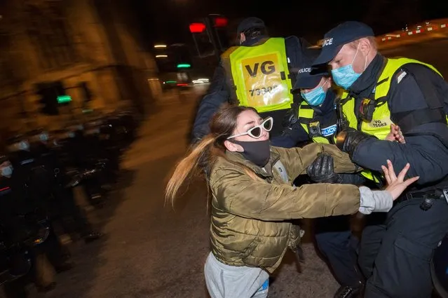 Police officers detain a woman during a “Kill the Bill” protest on April 04, 2021 in Bristol, England. The “Kill the Bill” protest is being held in opposition to the Police, Crime, Sentencing and Courts Bill. Last month police vans were torched and windows smashed at Bridewell police station. The proposed legislation, which would apply to England and Wales, covers a wide range of issues and would broaden the police's authority for regulating protests. (Photo by Andrew Lloyd/London News Pictures)
