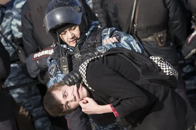 Police detain a protester in downtown Moscow, Russia, Sunday, March 26, 2017. Thousands of people crowded into Moscow's Pushkin Square on Sunday for an unsanctioned protest against the Russian government, the biggest gathering in a wave of nationwide protests that were the most extensive show of defiance in years. (Photo by Alexander Zemlianichenko/AP Photo)