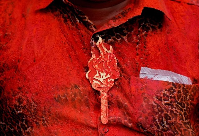 A person wears a badge of Shiv Sena (Uddhav Balasaheb Thackeray) party election symbol as it's smeared with colour after celebrations at the party office after election results outside the party office in Mumbai, India, on June 4, 2024. (Photo by Francis Mascarenhas/Reuters)