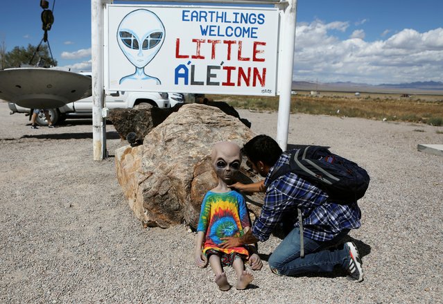 An attendee poses an alien doll at the Little A'Le'Inn in Rachel, Nevada on September 19, 2019. Situated about 150 miles (240 km) north of Las Vegas, the remote hamlet of just 50 year-round residents lacks a grocery store or even a gasoline station. (Photo by Jim Urquhart/Reuters)