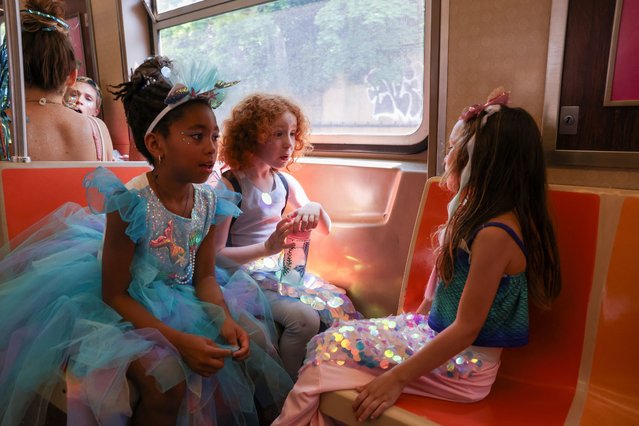 Children ride the train on their way to watch the Mermaid Parade in Coney Island, Brookly, New York City, U.S., June 22, 2024. (Photo by Caitlin Ochs/Reuters)