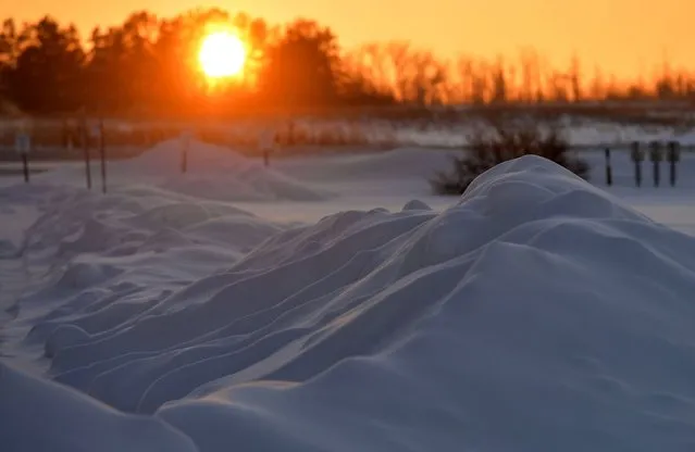 Snowdrifts seen on the roadside on Ellerslie Road in the southwestern part of Edmonton at sunset. The Edmonton and northern Alberta areas are experiencing a prolonged period of extreme cold conditions. Extreme frost warnings have been issued as cold wind temperatures between –40 and –55 remain this evening, posing increased health risks such as frostbite and hypothermia. On Monday, December 27, 2021, in Edmonton, Alberta, Canada. (Photo by Artur Widak/NurPhoto via Getty Images)