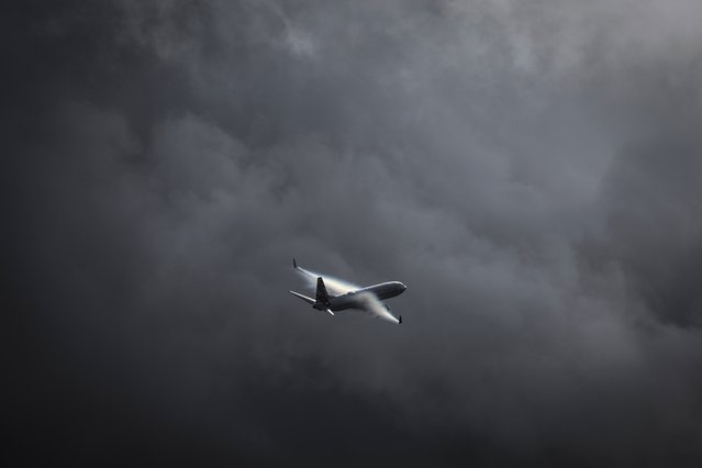 A Virgin Australia Airlines Boeing 737 plane flies as a storm approaches at Sydney International Airport on June 7, 2024. (Photo by David Gray/AFP Photo)