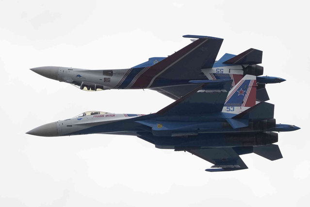 Sukhoi Su-35S jet fighters of the Russian Knights aerobatic team perform during the the International Maritime Defence Show “Fleet-2024” in Kronstadt, outside St. Petersburg, Russia, Wednesday, June 19, 2024. (Photo by Dmitri Lovetsky/AP Photo)