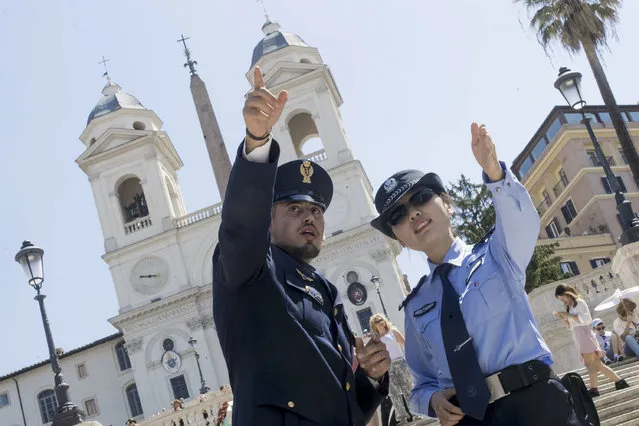 Italian and Chinese police officers patrol in front of the Spanish Steps, in Rome, Monday, June 5, 2017.  The Italian-Chinese joint patrolling is aimed at making Chinese tourists feel safe. (Photo by Claudio Peri/ANSA via AP Photo)