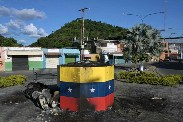 The remains of a statue of late Venezuelan President Hugo Chavez destroyed and burned during a protest against the government of Venezuelan President Nicolas Maduro are pictured in Mariara, Carabobo State, Venezuela, on July 31, 2024. Venezuelan President Nicolas Maduro said Wednesday he was willing to share evidence of his election win, with international pressure mounting for him to back up a disputed victory that has sparked deadly protests. (Photo by Yuri Cortez/AFP Photo)