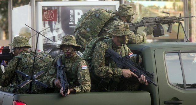 Special forces ride atop of a vehicle during a military parade marking the 20th anniversary of the “Operation Storm” that crushed Serb insurgency in Croatia, in Zagreb, Tuesday, August 4, 2015. (Photo by Darko Bandic/AP Photo)