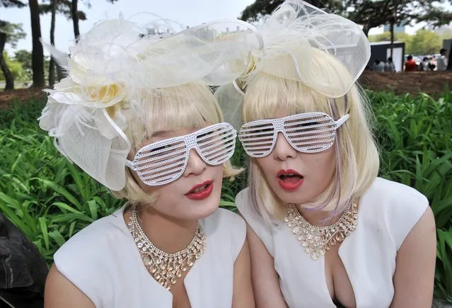 South Korean women dressed in costumes pose as they wait for a concert by US pop diva Lady Gaga outside Seoul's Olympic Stadium. Some religious groups in South Korea have opposed the concert, saying Lady Gaga has advocated homosexuality and performed in an explicitly sexual manner