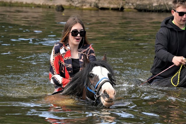 People ride their horses through the river during the Appleby Horse Fair, the annual gathering of gypsies and travellers in Appleby, Cumbria, North West England on Thursday, June 8, 2023. (Photo by Owen Humphreys/PA Images via Getty Images)