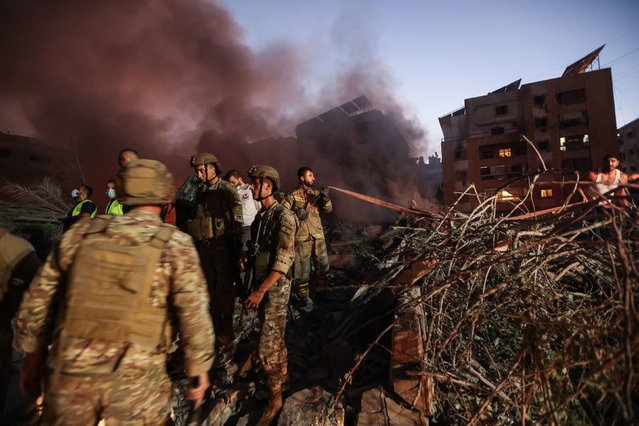 Lebanese soldiers gather at the scene of Israeli airstrikes in the Haret Hreik neighborhood of Beirut’s southern suburbs on Friday, September 27, 2024. Hezbollah’s longtime leader, Hassan Nasrallah, was killed Friday in a massive bombardment that was the first of nearly 48 hours of incessant airstrikes. (Photo by Ibrahim Amro/AFP Photo)