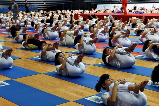 People practice yoga at a stadium in Yiwu, Zhejiang province, China June 23, 2016. (Photo by Reuters/Stringer)