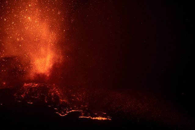 Lava flows from the Mount Etna volcano on the southern Italian island of Sicily near Catania on August 15, 2014. Mount Etna is one of the most active volcanoes in the world and is in an almost constant state of activity. (Photo by Marco Restivo/Etna Walk via Reuters)