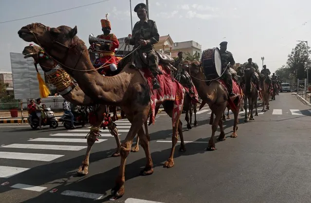 Border Security Force (BSF) soldiers ride their camels as they take part in a rehearsal for a road show ahead of the visit of U.S. President Donald Trump, in Ahmedabad, February 23, 2020. (Photo by Francis Mascarenhas/Reuters)