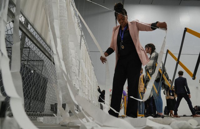 An election worker unveils early voting results at Fulton County Operations Hub and Elections Center, in Fairburn, Georgia on November 5, 2024. (Photo by Cheney Orr/Reuters)