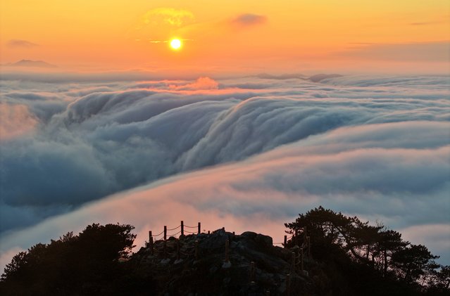 A sea of clouds cascades like a waterfall down the peaks of Yingpan mountain with a height of 1724 meters on November 26, 2024 in Ji'an, Jiangxi Province of China. (Photo by Li Jianping/VCG via Getty Images)