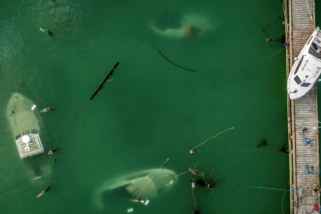 An aerial view taken on October 22, 2023 shows sunken boats in the harbour of Rodvig, Denmark following the storm which hit parts of Denmark on Friday and Saturday. (Photo by Mads Claus Rasmussen/Ritzau Scanpix via AFP Photo)