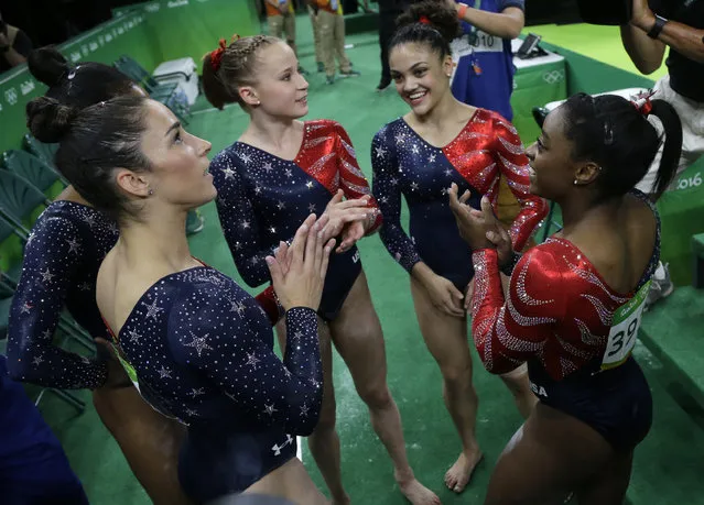 U.S. gymnasts, from left, Aly Raisman, Madison Kocian, Lauren Hernandez and Simone Biles wait for the score during the artistic gymnastics women's qualification at the 2016 Summer Olympics in Rio de Janeiro, Brazil, Sunday, August 7, 2016. (Photo by Julio Cortez/AP Photo)