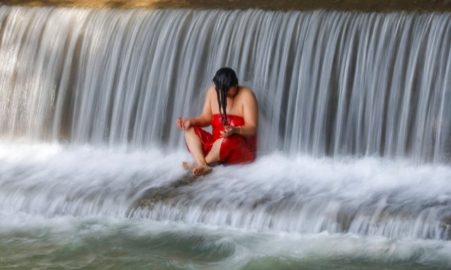 A Nepalese Hindu devotee takes a holy bath in the Salinadi River during the month-long Madhav Narayan festival in Sankhu, Nepal, 31 January 2025. The festival is a month-long event devoted to religious fasting, holy bathing and the study of the Swasthani book, which is dedicated to the deities Shiva and Swastania. (Photo by Narendra Shrestha/EPA/EFE)