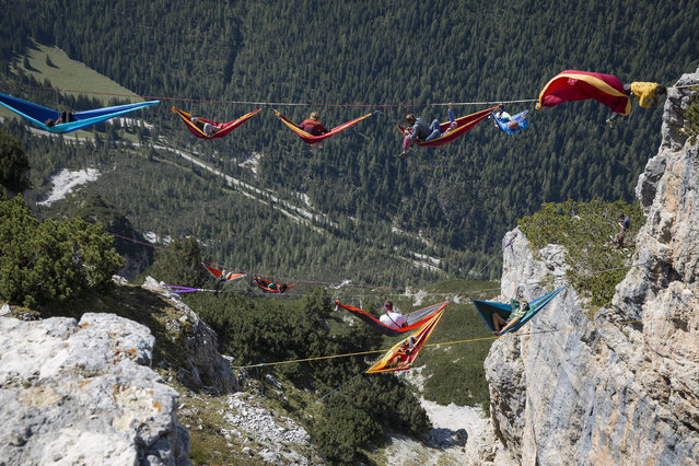 Doesn’t taking a nap in a hammock outdoors sound lovely? Perhaps not when you’re hanging in the air, thousands of feet above ground, between two mountains in the Italian Alps! Which is exactly what these adventurous folks did during the International Highline Meeting in Monte Piana, Italy. (Photo by Sebastian Wahlhuetter Photography)