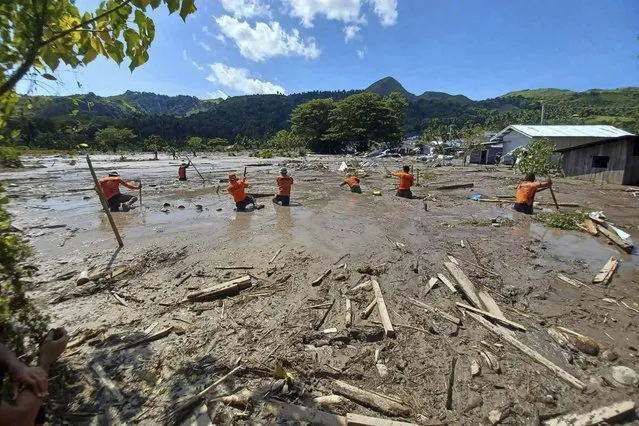 In this photo provided by the Philippine Coast Guard, rescuers continue their search for missing bodies at Barangay Kusiong, Datu Odin Sinsuat, Maguindanao province, southern Philippines on Monday, October 31, 2022. Several people have died in one of the most destructive storms to lash the Philippines this year with dozens more feared missing after villagers were buried in a boulder-laden mudslide. (Photo by Philippine Coast Guard via AP Photo)