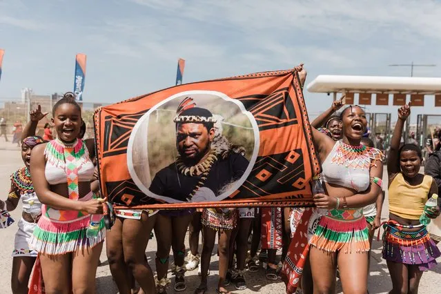 Young girls carry a banner of King Misuzulu ka Zwelithini at the king's coronation at the Moses Mabhida Stadium in Durban on October 29, 2022. Tens of thousands of people in colourful regalia gathered at a huge soccer stadium in the coastal city of Durban to celebrate the official coronation of South Africa's Zulu king. Misuzulu Zulu, 48, ascended the throne once held by his late father, Goodwill Zwelithini, who died in March 2021, after more than 50 years on the throne. (Photo by Rajesh Jantilal/AFP Photo)