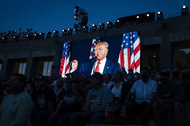 U.S. President Donald Trump is displayed on a screen as he speaks during an event at Mount Rushmore National Memorial in Keystone, South Dakota, U.S., on Friday, July 3, 2020. The early Independence Day celebration, which will feature a military flyover and the first fireworks in more than a decade, is expected to include about 7,500 ticketed guests who won't be required to wear masks or socially distance despite a spike in U.S. coronavirus cases. (Photo by Al Drago/Bloomberg via Getty Images)