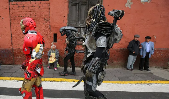 People dressed as in movie costume walk near Saint Rose's Church during celebrations of the anniversary of Santa Rosa de Lima (Saint Rose of Lima), patroness of Latin America and the Philippines, in Lima, Peru, August 30, 2016. (Photo by Mariana Bazo/Reuters)