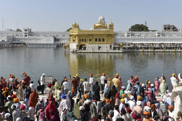 Sikh devotees arrive to pay their respects at the Golden Temple, Sikhism's holiest shrine, on the occasion of 'Baisakhi', a spring harvest festival for Sikhs and Hindus in Sikkhism, in Amritsar, India, Sunday, April 13, 2025. (Photo by Prabhjot Gill/AP Photo)