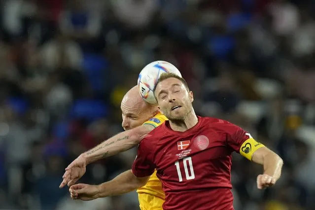 Denmark's Christian Eriksen, foreground, and Australia's Aaron Mooy jump for the ball during the World Cup group D soccer match between Australia and Denmark, at the Al Janoub Stadium in Al Wakrah, Qatar, Wednesday, November 30, 2022. (Photo by Francisco Seco/AP Photo)