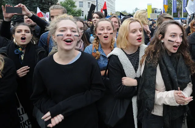 Pro abortion protesters, dressed in black  to signify grief in terms of the abortion ban, shout slogans during a demonstration in front of the Polish parliament, in Warsaw, Poland, Thursday, September 22, 2016. Poland’s lawmakers on Thursday opened a divisive debate on changing the restrictive anti-abortion law, among Europe’s toughest, in this predominantly Catholic nation. (Photo by Alik Keplicz/AP Photo)