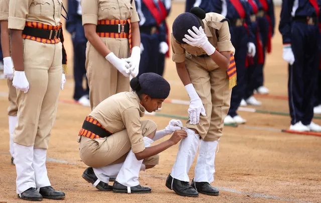 Indian security personnel adjust a uniform during full-dress rehearsal ahead of the 74th Republic day celebrations in Bangalore, India, 24 January 2023. The Republic Day of India marks the adoption of the constitution of India and the transition of the country to a Republic on 26 January 1950. (Photo by Jagadeesh N.V./EPA/EFE)