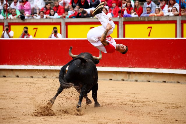 A “recortador” jumps over a fighting bull in the bullring, at the San Fermin festival in Pamplona, Spain, on July 12, 2025. (Photo by Albert Gea/Reuters)