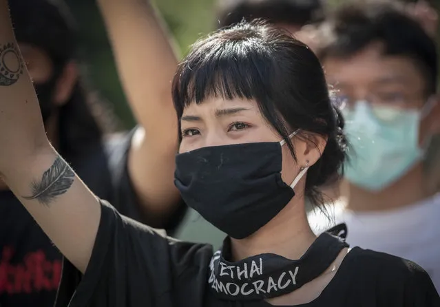 Pro-democracy protesters shout slogans during a protest at the central business district in Bangkok, Thailand, Thursday, October 15, 2020. Thailand's government declared a strict new state of emergency for the capital on Thursday, a day after a student-led protest against the country's traditional establishment saw an extraordinary moment in which demonstrators heckled a royal motorcade. (Photo by Gemunu Amarasinghe/AP Photo)
