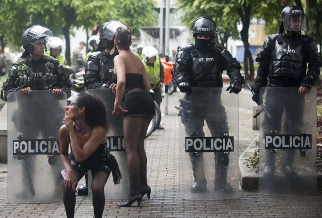 Students perform by riot police during a protest in Medellin, Antioquia department, Colombia on March 21, 2013, demanding a better and free education and an alternative university reform. (Photo by Raul Arboleda/AFP Photo)