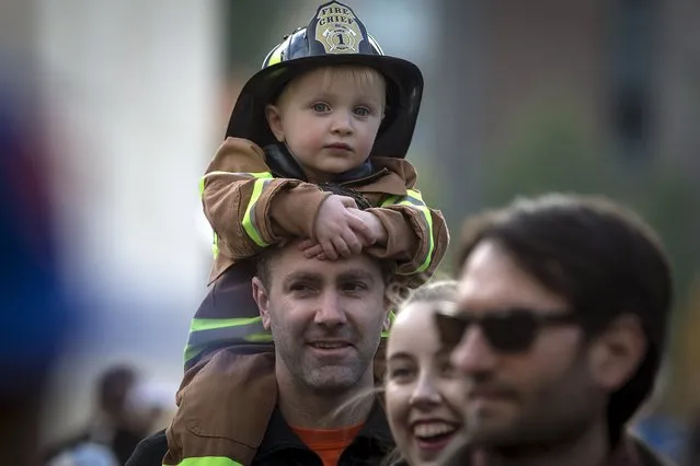 A child dressed as a fireman rides on an adult's shoulders as they take part in the Children's Halloween day parade at Washington Square Park in the Manhattan borough of New York October 31, 2015. (Photo by Carlo Allegri/Reuters)