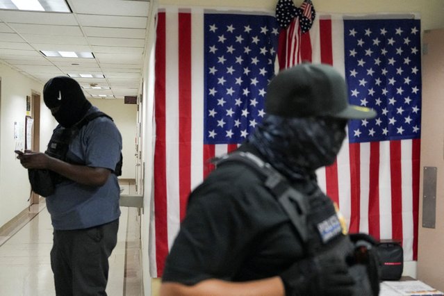 Federal immigration officers wait in a hallway to detain targeted migrants at U.S. Immigration Court in Manhattan, New York City, on September 4, 2025. (Photo by Christian Monterrosa/Reuters)